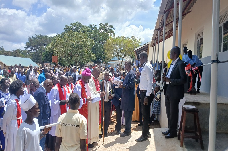 Bishop Andaku and the clergy with stakeholders officially opening the new classroom blocks. Photo Credit; Matata Benzamin
