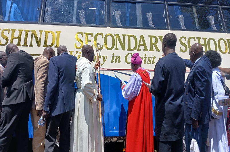 Bishop Charles Collins Andaku commissioning and praying on the bus. Photo Credit; Matata Benzamin