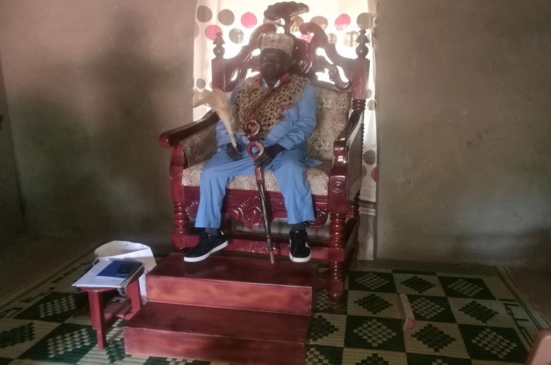 Manase Yuma Amuku enjoying his seat shortly after his election as the Agofe of Lugbara Kari in 2023